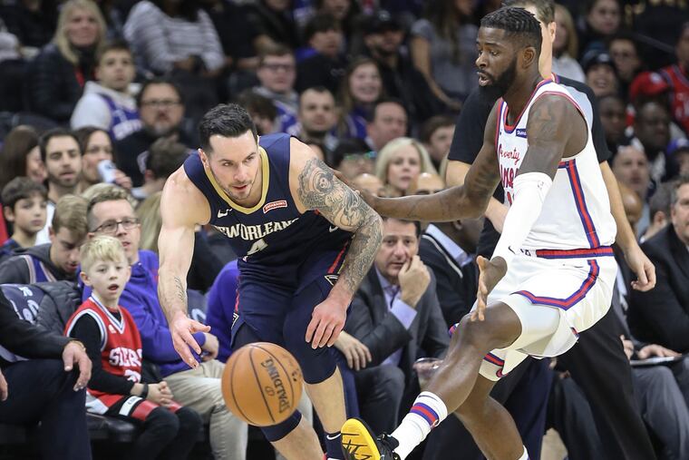 The Sixers' James Ennis III watches the Pelicans' JJ Redick go for the loose ball during the first quarter at the Wells Fargo Center on Friday.