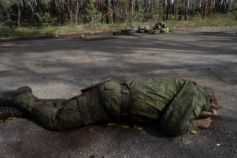 Dead bodies of Russian servicemen lie on the ground in the recently recaptured town of Lyman, Ukraine, on Monday.