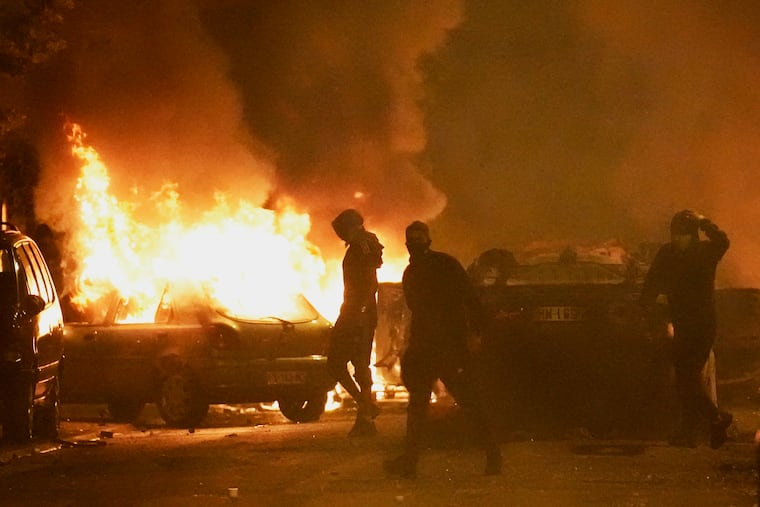 Youths clash with police forces as cars burn in Nanterre, outside Paris, on Thursday, June 29.