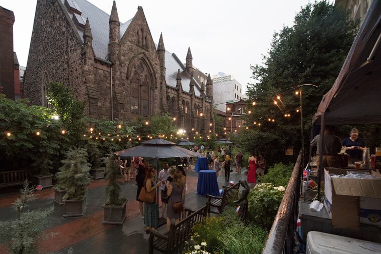 Patrons enjoy cocktails on a drizzly night at the Mutter Museum's pop-up beer garden July 3.
