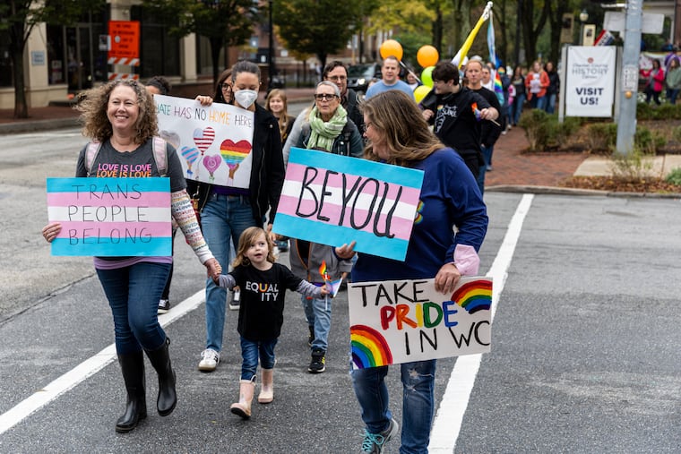 Katrina Nolan, of West Chester, Pa., (left) and her daughter Juliet Nolan, 3, (center), are out marching with people in the community to rally and celebrate OutFest in West Chester, Pa., Saturday, Oct., 1, 2022.