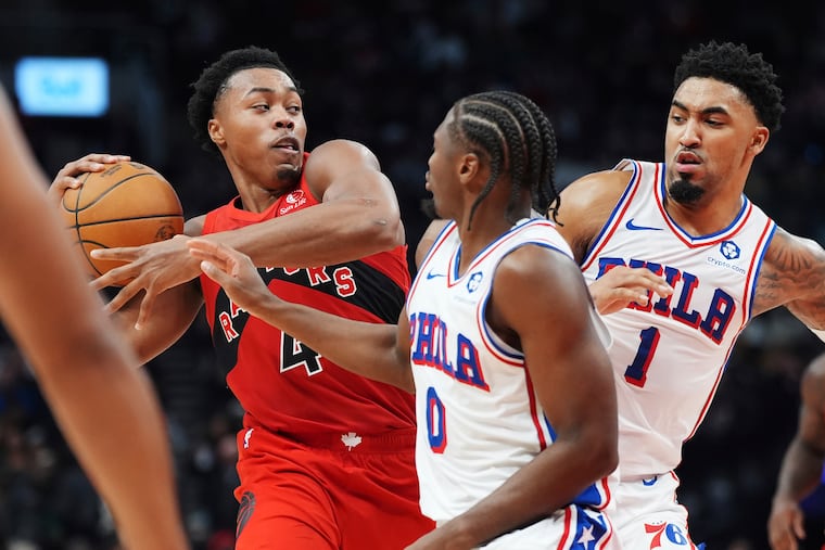 Toronto Raptors forward Scottie Barnes protects the ball from Sixers Tyrese Maxey and KJ Martin on Friday.