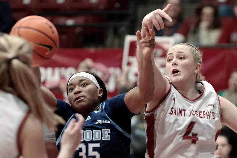 Rhode Island No. 35 Sayawni Lassiter and St. Joe's No. 4 Laura Ziegler battle for a rebound.