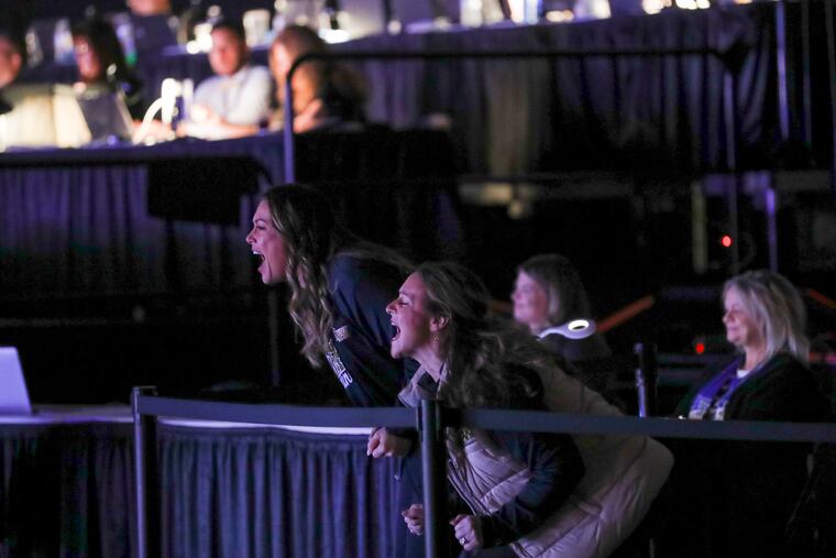 Coaches Veronica Hayes, left, and Michele Sorkin-Socki cheer on their team while they perform their second and final routine for the judges and crowd at the Kay Bailey Hutchison Convention Center in Dallas, Texas on Sunday Jan. 22, 2023. The George Washington High School cheer team became the first Philadelphia School District cheerleaders in history to qualify for nationals.