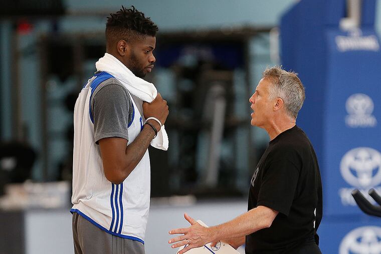 Nerlens Noel talks with head coach Brett Brown during a practice a few weeks ago.