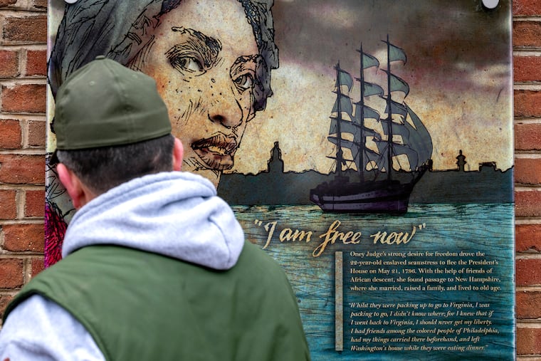 A worker pauses while re-hanging a panel of Oney Judge at the President’s House in Independence National Historical Park in February.