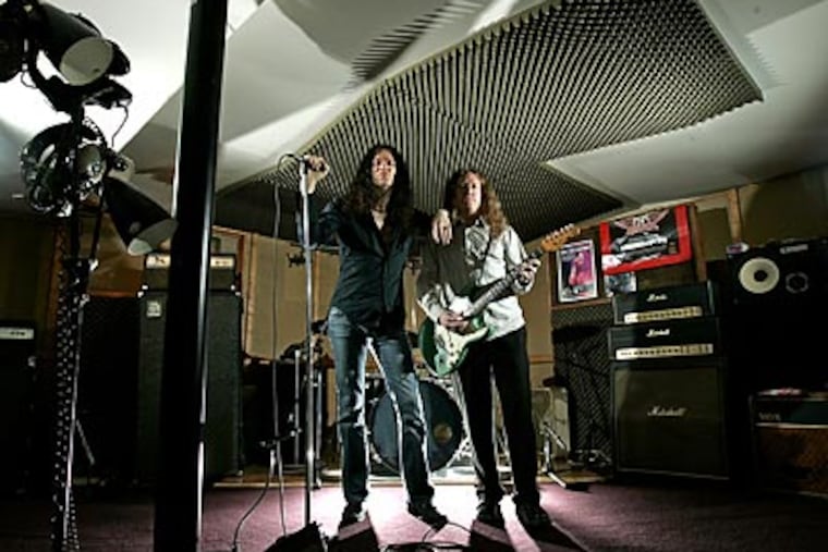 Paul Sinclair (left) and Paul Hammond's band Get the Led Out has been selling out shows playing Led Zeppelin's music. (Michael Perez/Staff Photographer)