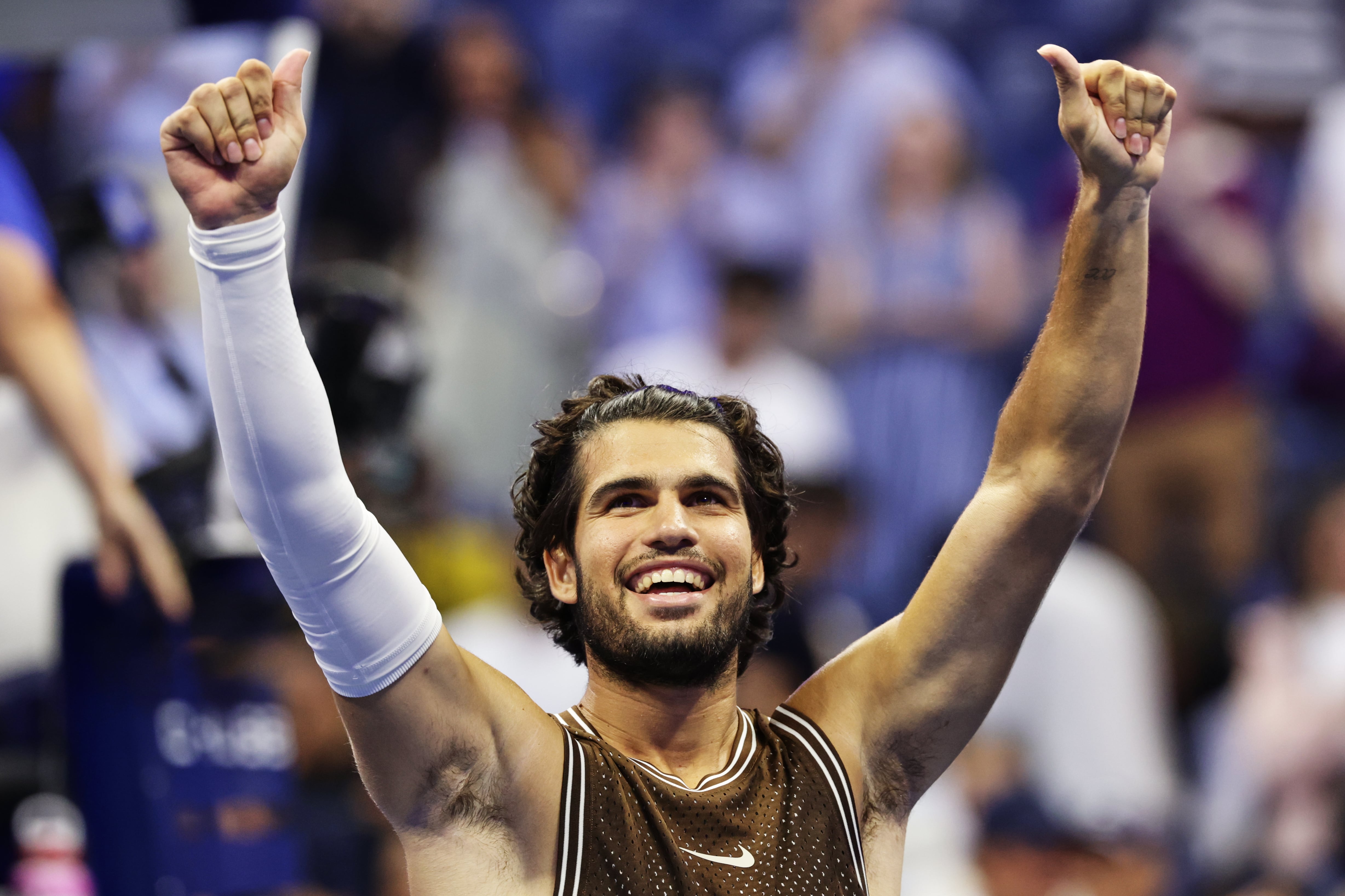 Carlos Alcaraz recovers after dropping the first set to reach the second round at the US Open
