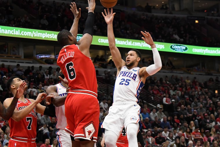 Philadelphia 76ers guard Ben Simmons (25) shoots as Chicago Bulls forward Cristiano Felicio (6) defends during the first half of an NBA basketball game Saturday, April 6, 2019, in Chicago. (AP Photo/David Banks)