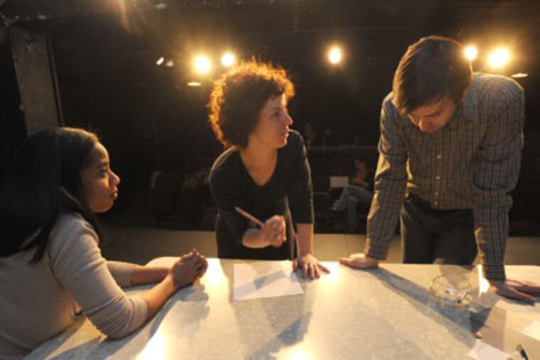 At the Adrienne Theater in Philadelphia, the Flashpoint Theatre Company rehearses the World Premiere of Jacqueline Pardue Goldfinger's Slip/Shot on April 3, 2012. Here, director Rebecca Wright (center) works with actors Taysha Canales (left) and Kevin Meehan. APRIL SAUL / Staff Photographer