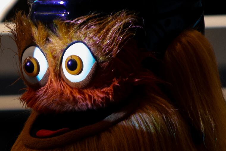 Gritty's eyes light up from a projector overhead as he makes a special appearance at a panel called "The Brains Behind Gritty" at Philly Tech Week in Center City in May.