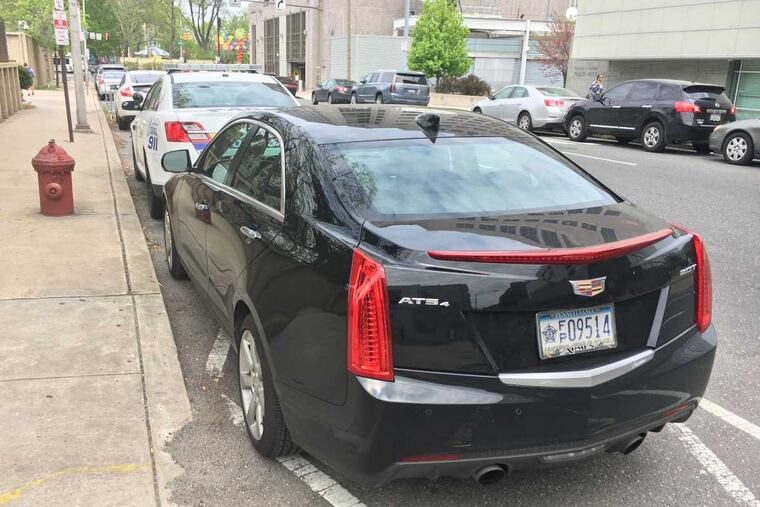 This vehicle with FOP plates hits the trifecta: It's parked in a no stopping zone, it is too close to the fire hydrant and is blocking the parking lot exit.