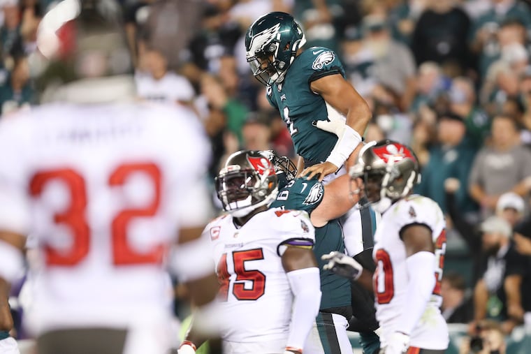 Eagles quarterback Jalen Hurts celebrates his fourth quarter touchdown run with teammate offensive guard Landon Dickerson against the Tampa Bay Buccaneers on Thursday, October 14, 2021 in Philadelphia.