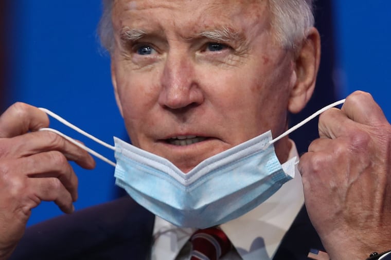 U.S. President-elect Joe Biden removes his protective mask before delivering remarks about the U.S. economy during a press briefing at the Queen Theater on November 16, 2020 in Wilmington, Delaware. Mr. Biden and his advisors continue to work on the long term economic recovery plan his administration will try to put in place when he takes office. (Photo by Joe Raedle/Getty Images)
