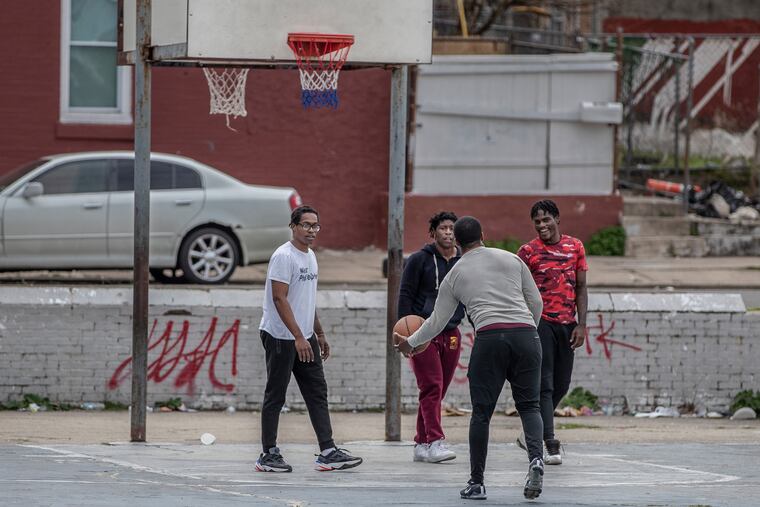 Basketball players at the West Mill Creek playground were not practicing social distancing as they played a game of two on two Tuesday afternoon. Some playgrounds in the city still have basketball hoops up and people congregating to play games.
