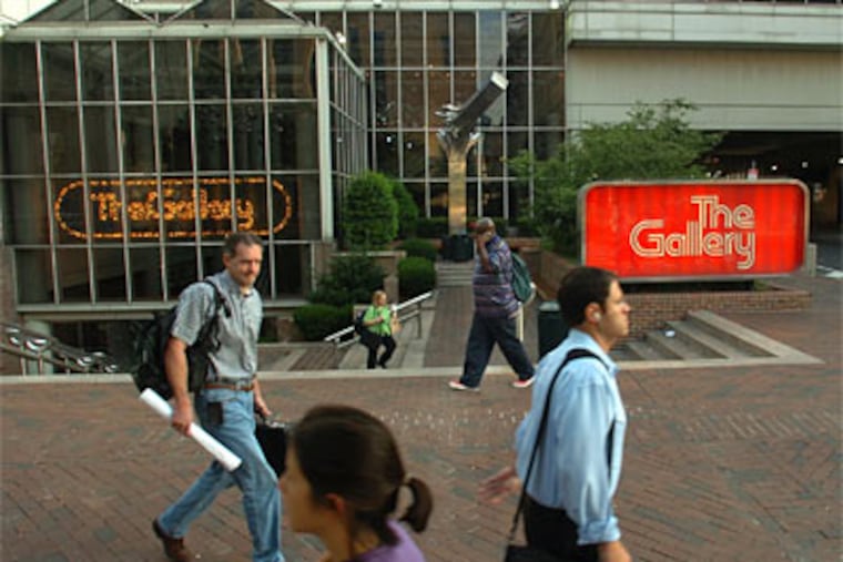 Morning commuters walk past the entrance to The Gallery at the corner of Market and 9th Streets. Foxwood Casino is considering the site as an alternative location to its waterfront parcel to build one of Philadelphia's two casinos. (Photo by Clem Murray / Inquirer)