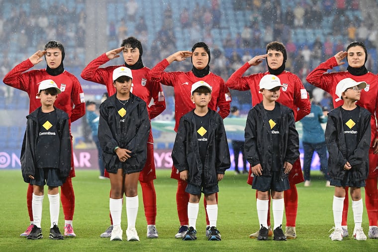 Iranian soccer players during the national anthem before a game Sunday against the Philippines in the women's Asian Cup in Robina, Australia.