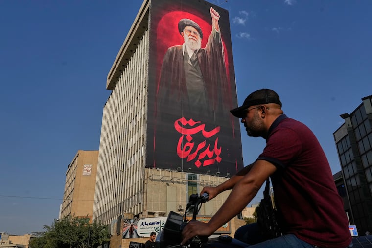 A man rides on his motorbike past a billboard with a message that reads in Farsi: " We must rise up" and an image of the late Iranian Supreme Leader Ayatollah Ali Khamenei, who was killed during the U.S. and Israel strikes on Feb. 28, in Tehran, Iran, Saturday, Aug. 15, 2026. Leaders in Persian Gulf region states are growing frustrated with President Donald Trump's cycle of threats and withdrawals in the war.