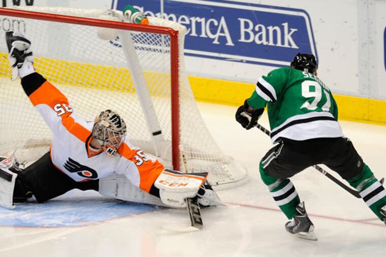 Dallas Stars center Tyler Seguin (91) scores his first goal of the second period on Philadelphia Flyers goalie Steve Mason (35) during an NHL hockey game, Saturday, Dec. 7, 2013 in Dallas. (Matt Strasen/AP)