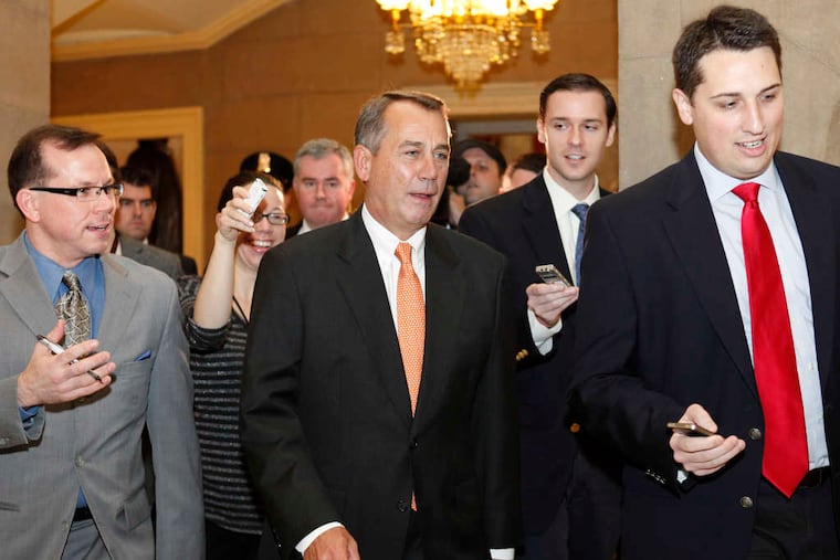 House Speaker John A. Boehner (R., Ohio), center, surrounded by reporters after exiting the pro forma House session that passed the two-month payroll-tax cut extension.
