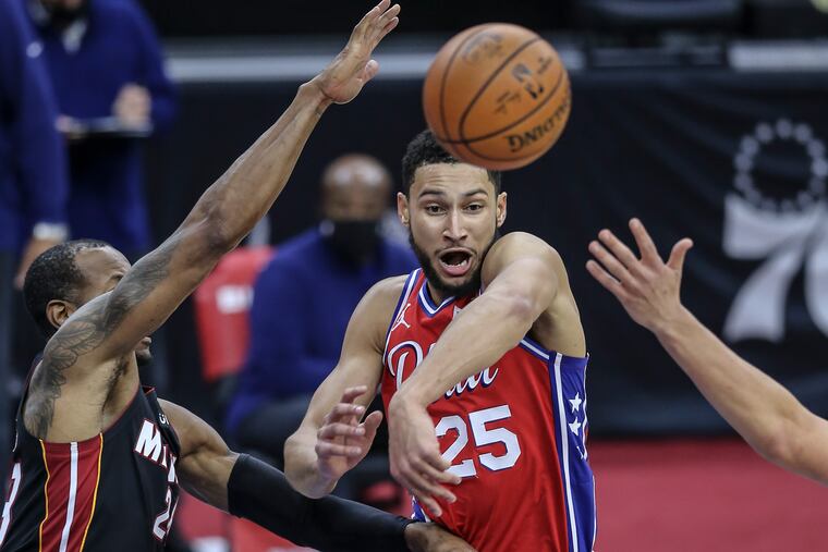 Ben Simmons throws a pass by the Heat's Andre Iguodala during the second quarter of Thursday's 125-108 win. He recorded 10 points, 10 rebounds, 12 assists and three steals.