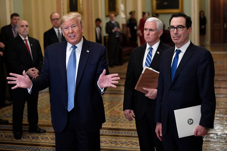 President Donald Trump, left, standing with Vice President Mike Pence and Treasury Secretary Steven Mnuchin, right, talks to reporters about the coronavirus outbreak on Tuesday, March 10, 2020, on Capitol Hill in Washington. (AP Photo/Susan Walsh)