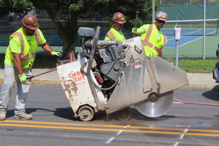 A worker opens a section of street in Ocean City, N.J., on Sept. 12, 2023, at the start of land-based probing along the right-of-way where a power cable for New Jersey's first offshore wind farm was proposed to run. Orsted scrapped the project on Oct. 31, 2023, citing supply-chain problems and high interest rates.