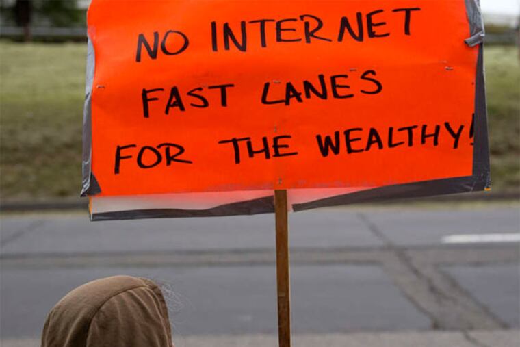 A demonstrator protests in favor of Internet neutrality outside the FCC headquarters in Washington. (ANDREW HARRER / Bloomberg News)