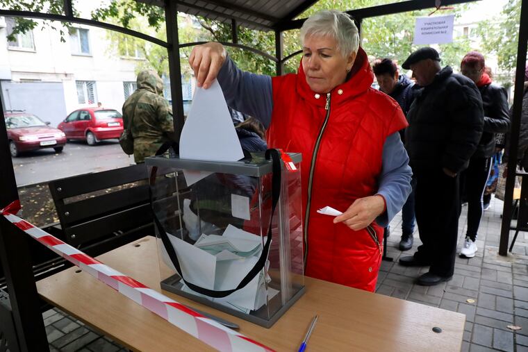 A woman votes during a referendum in a mobile polling station in Mariupol, Donetsk People's Republic, controlled by Russia-backed separatists on Friday.