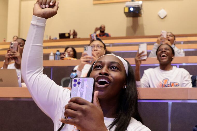 Lincoln University women's basketball team member Joy Morton raises her arm and cheers when Lincoln is called during the NCAA tournament seeding watch party the team had at Lincoln University. The Lions, coming off their first CIAA championship, will be making their first ever NCAA tournament appearance when they face Glenville State later this week.