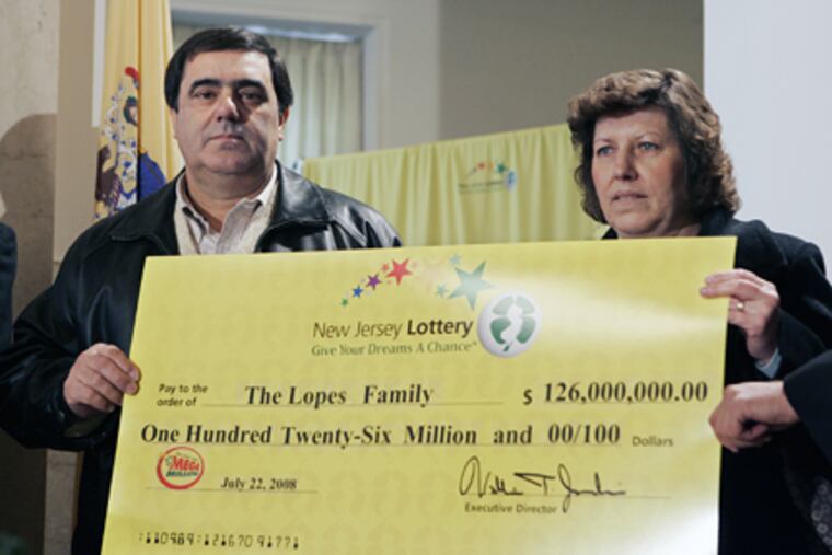 Mario and Clelia Lopes of Union County, N.J., with a ceremonial check that shows the annuity value of the Mega Millions jackpot they won in July. The Lopes, who were introduced to the media on Monday in Trenton on Monday, took the cash value of $75.5 million, before fedeal taxes.