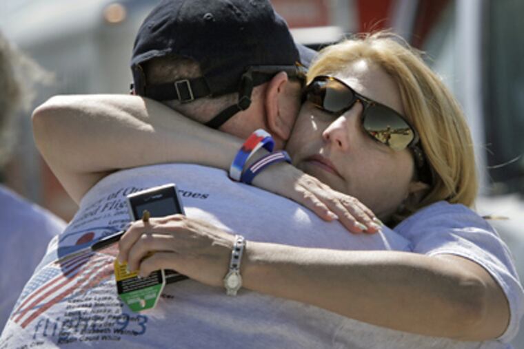Ken Nacke, whose brother Louis Nacke was a passenger aboard Flight 93, is embraced by his wife, Marci Nacke, at the temporary memorial in Shanksville, Pa on Thursday. (Laurence Kesterson / Staff Photographer)