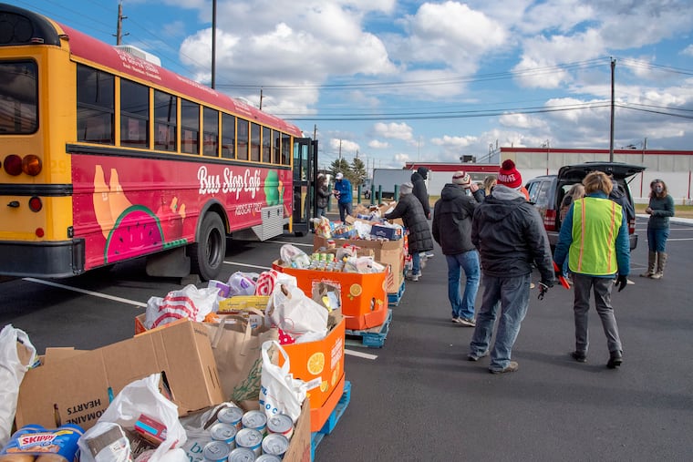 Volunteers take in donations at the Food Bank of South Jersey's "Stuff the Bus" MLK Day of Service event in Pennsauken Jan. 18, 2021, to commemorate the life and legacy of Dr. Martin Luther King Jr. Besides the food donations, every $1 donated provides 3 meals to hungry South Jersey neighbors in need.