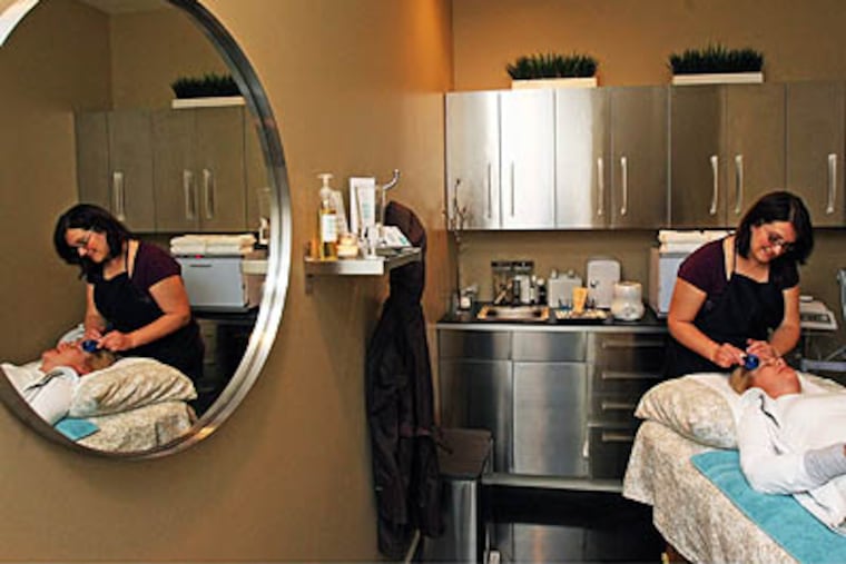Lynaia Pulido works on Linnea Frary at the Wax Bar in Seattle, Washington, on April 2, 2010. The new salon spread word to potential customers through Facebook and Twitter. (Mark Harrison/Seattle Times/MCT)