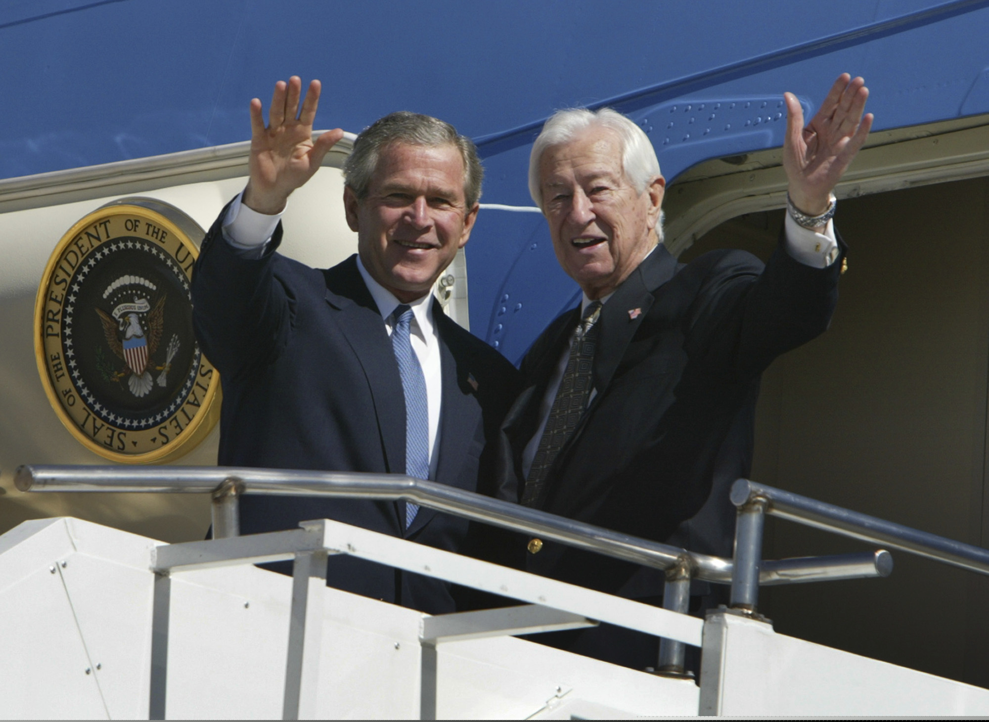 FILE - In this March 8, 2004, file photo, then-President George W. Bush (left) waves with Rep. Ralph Hall (R., Texas) as they step off Air Force One upon Bush's arrival in Dallas. Former Rep. Hall, the oldest-ever member of the U.S. House, has died at age 95.