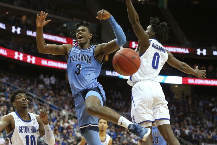 Brandon Slater, center, of Villanova gets fouled by Kadary Richmond of Seton Hall during the 1st half on Jan. 1, 2022 at the Prudential Center in Newark, N.J.