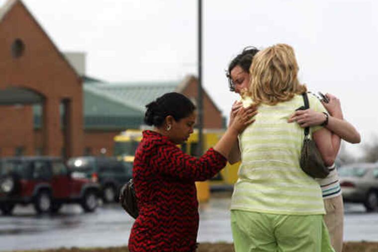 console one another outside the First Baptist Church in Maryville, Ill., where a gunman killed the Rev. Fred Winters, above, and wounded himself before he was subdued.