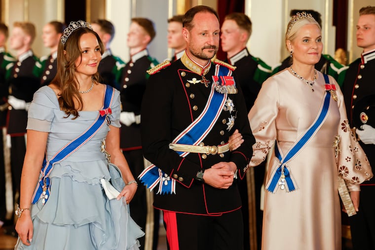 Norway's Princess Ingrid Alexandra (from left), Crown Prince Haakon, and Crown Princess Mette-Marit on their way to a gala dinner on April 8, 2025, at the Palace in Oslo.
