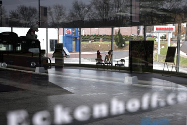 A Hummer decorated with a teddy bear is all that remains in the showroom after new and used cars were repossessed from Scott Eckenhoff. "I never anticipated this," said Eckenhoff, who is trying to salvage his business. (David Swanson / Staff Photographer)