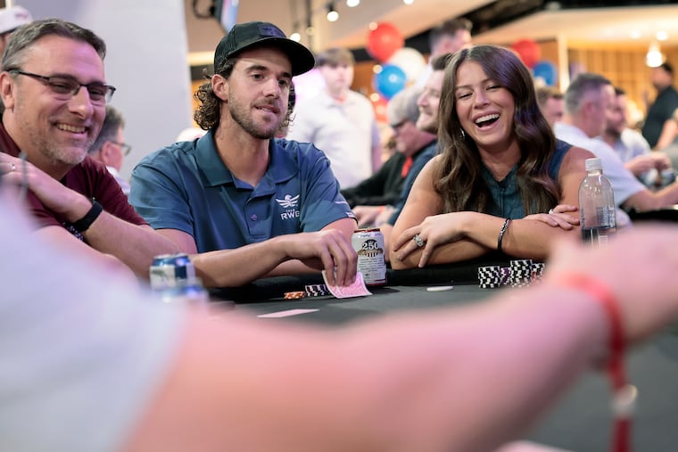 Phillies pitcher Aaron Nola (center) and his wife, Hunter (right), play poker while hosting their second charity poker tournament and auction at Citizens Bank Park.