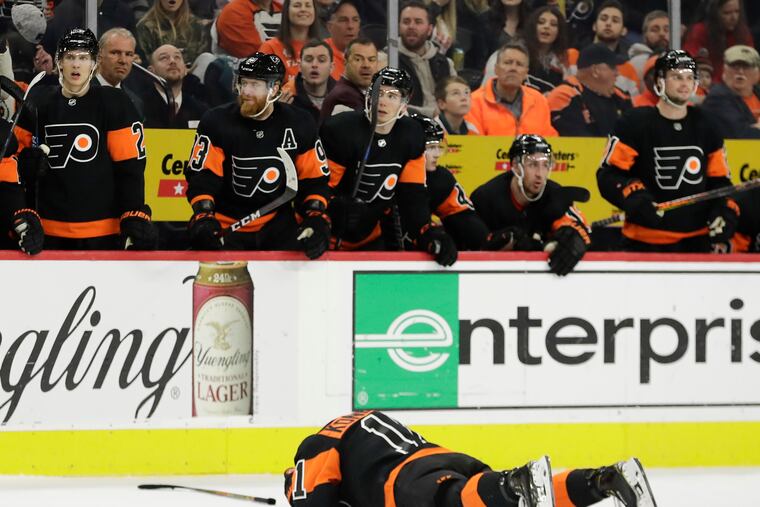 Flyers right wing Travis Konecny lays on the ice after getting hit against the Ottawa Senators on Saturday. The injury resulted in several fights.