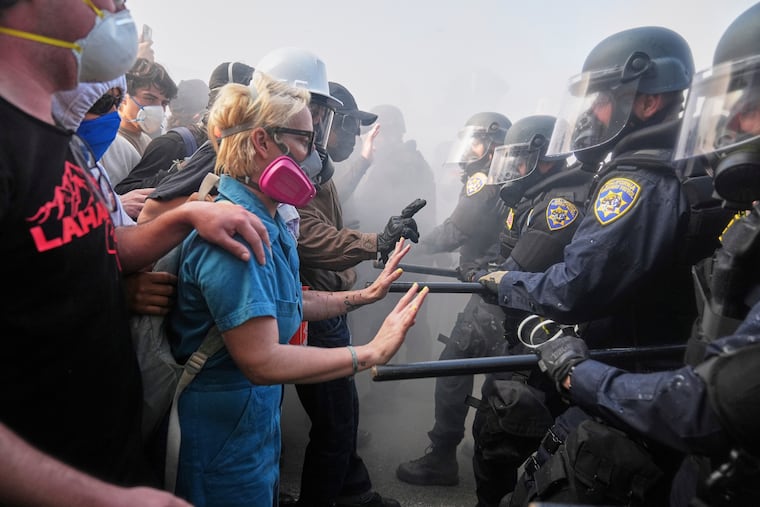 Protesters against President Donald Trump's immigration crackdown confront police near the Metropolitan Detention Center in downtown Los Angeles, June 8, 2025. Protests of the Trump administration's deportation policies are only expected to grow, yet the president is carelessly fanning the flames with his dangerous dehumanizing rhetoric, the Editorial Board writes.