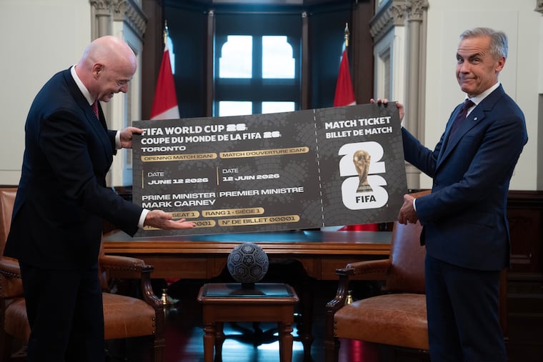 Canada Prime Minister Mark Carney (right) is presented with a novelty World Cup ticket by FIFA president Gianni Infantino on Oct. 10.