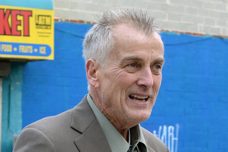 Former sportscaster Don Tollefson pauses on a corner as he walks toward his apartment in North Philly December 22, 2014. ( TOM GRALISH / Staff Photographer )