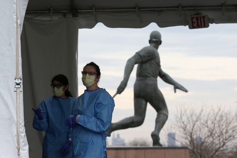 Medical workers wait to test coronavirus patients outside of Citizens Bank Park, where the Phillies had been scheduled to play their home opener against the Milwaukee Brewers on April 2.