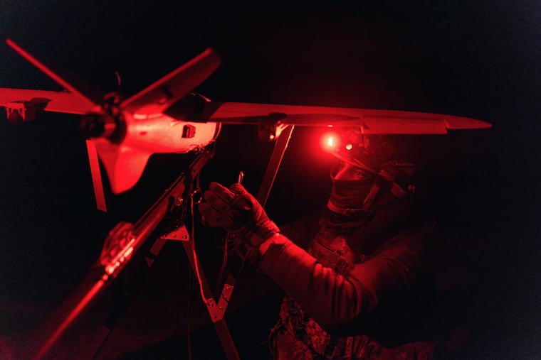 A soldier of the 127th Separate Territorial Brigade launches a drone to search for Russian attack drones at the front line in the Kharkiv region Saturday, March 14, 2026.