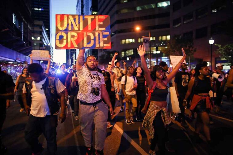 Black Lives Matter demonstrators march along Market Street on Sunday, July 10, 2016, in Center City.