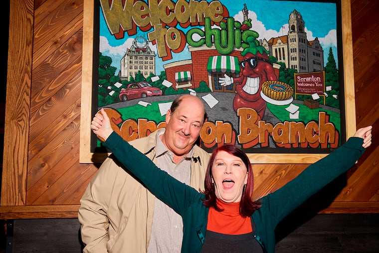 This undated photo released by Chili's shows actors Brian Baumgartner, left, who played Kevin Malone, and Kate Flannery, who played Meredith Palmer in the TV series "The Office," posing for a photo in a soon-to-be opened Chili's in Dickson City, Pa.