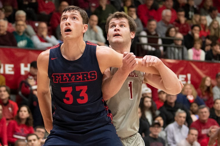 St. Joseph's Ryan Daly and Dayton's Ryan Mikesell battle for a rebound during the second half.