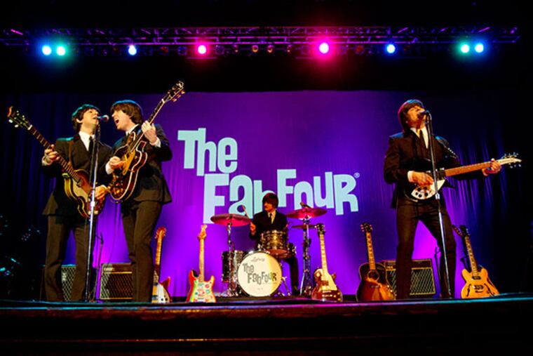 The Fab Four: Paul McCartney (Ardy Sarraf), George Harrison (Gavin Pring), Ringo (Erik Fidel) and John Lennon (Ron McNeill) re-creating the Beatles first performance on the Ed Sullivan Show onstage at the Scottish Rite Theatre in Collingswood, February 9, 2014. ( DAVID M WARREN / Staff Photographer )